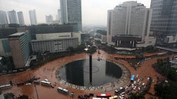 Seasonal rains triggered massive flooding in Indonesia's capital on Thursday, killing at least four people, triggering the evacuation of at least , and paralyzing much of the city.